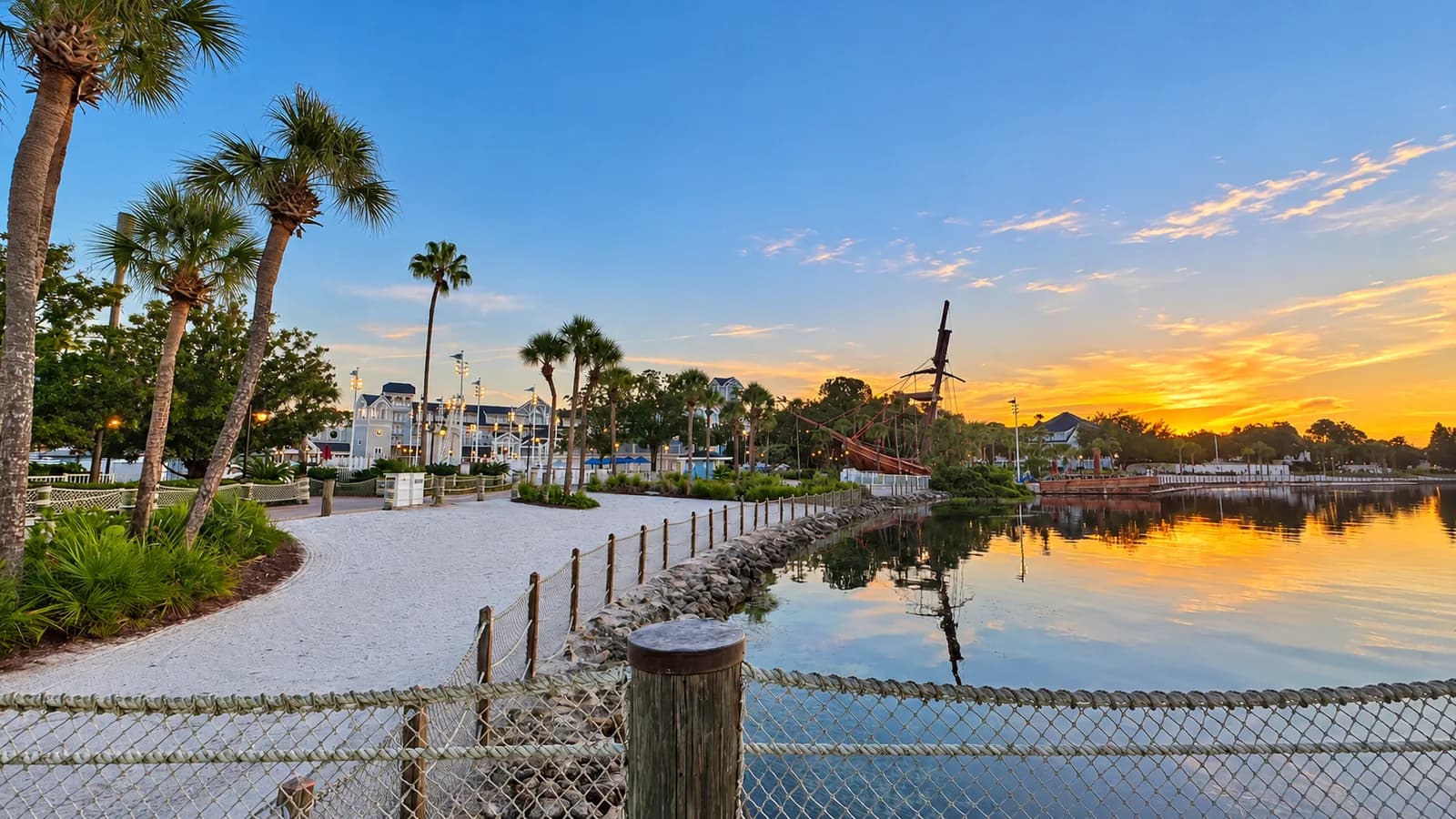 Resort waterfront and pirate ship at sunset